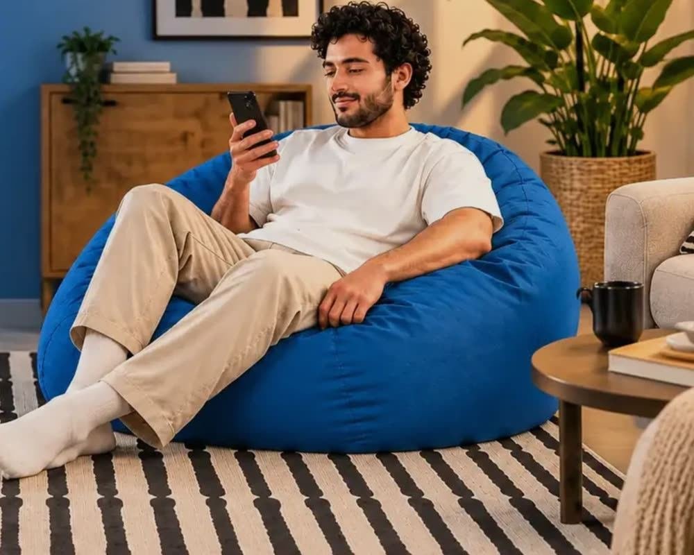 A shopper relaxing on a Khyaal striped rug at home